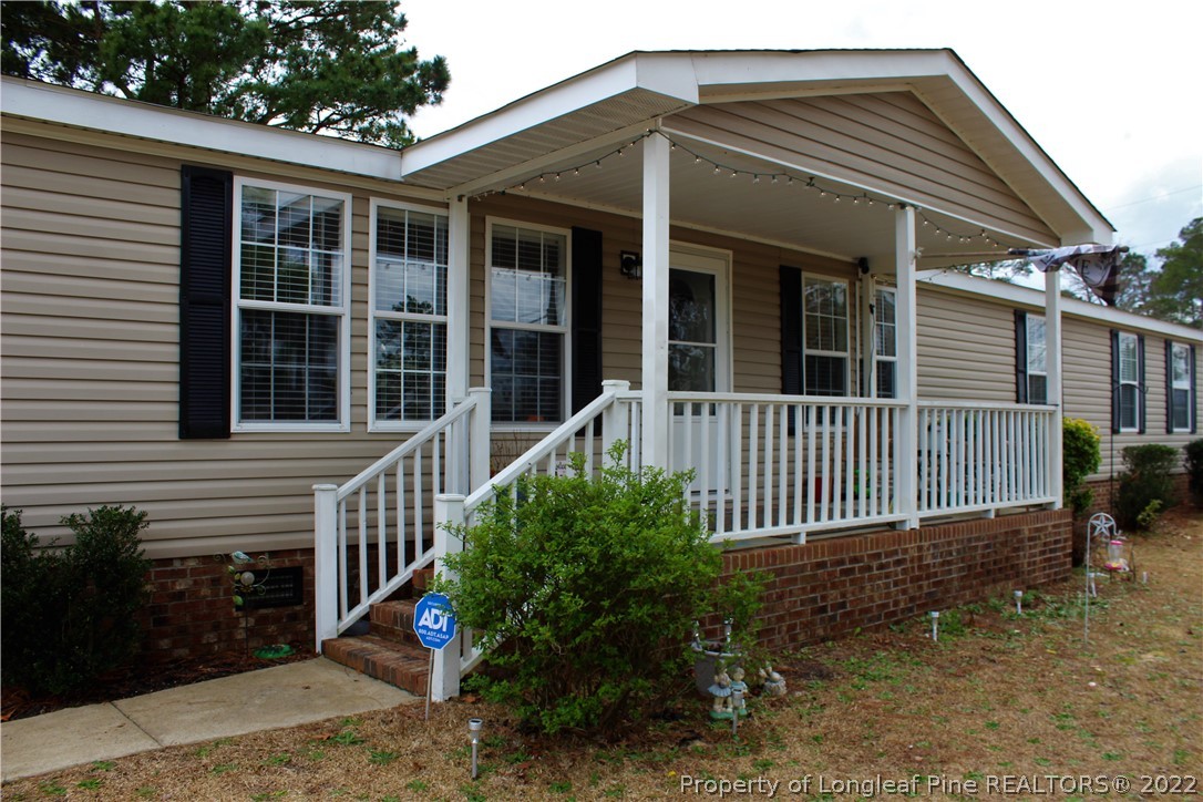 6520 Faircloth Bridge Road Stedman, NC 28391 - Photo 2 of 39 a front view of a house with a garden