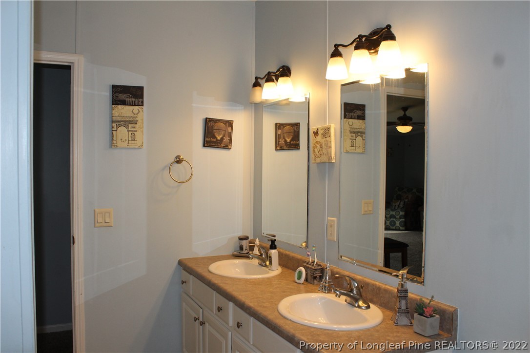 6520 Faircloth Bridge Road Stedman, NC 28391 - Photo 23 of 39 a bathroom with a sink and a mirror