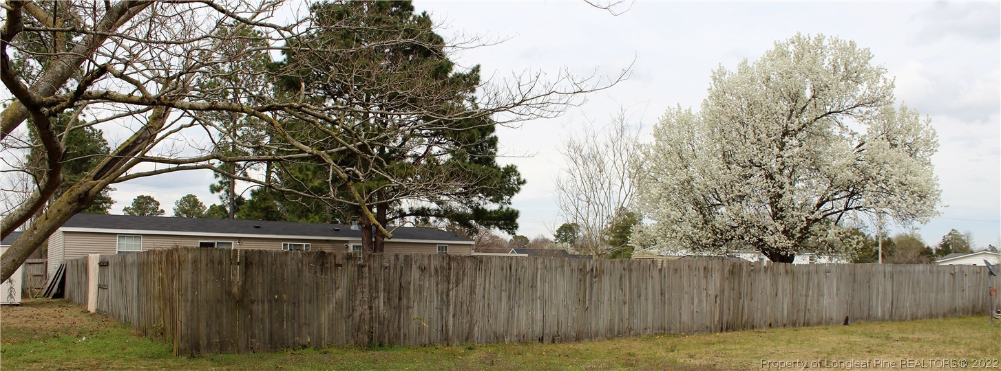 6520 Faircloth Bridge Road Stedman, NC 28391 - Photo 35 of 39 a view of backyard with wooden fence and large trees