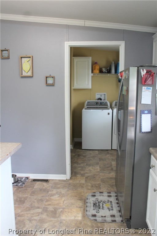 6520 Faircloth Bridge Road Stedman, NC 28391 - Photo 8 of 39 a view of a hallway with a washer and dryer