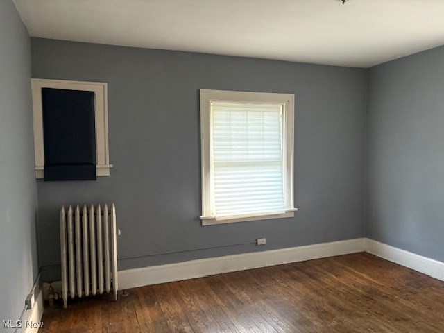 3258 Berkshire Road Cleveland, OH 44118 - Photo 17 of 23 Unfurnished room with radiator and hardwood / wood-style floors