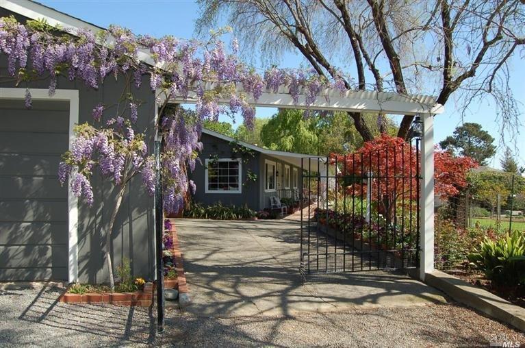 2206 Oak Knoll Road Novato, CA 94947 - Photo 1 of 1 Blooming wisteria welcomes you through a patio to a uniquely American front porch; large, open and comfortable.