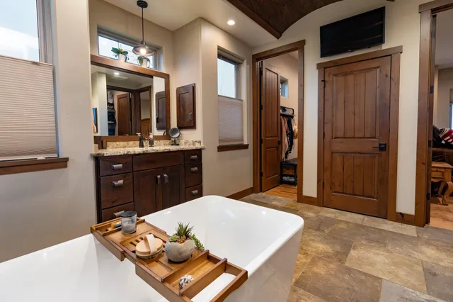 a living room with stainless steel appliances kitchen island granite countertop furniture and a refrigerator