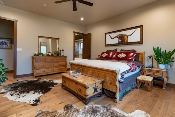 a bedroom with a bed and a chandelier