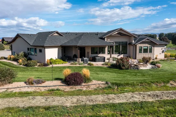 a view of a house with a garden and yard