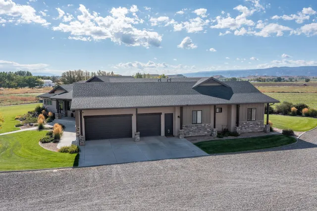 an aerial view of a house with big yard
