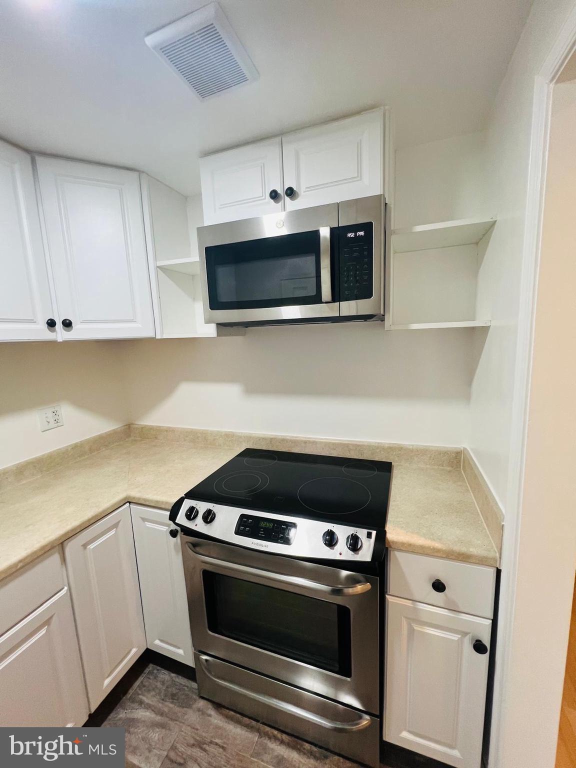 13249 # Lane Silver Spring, MD 20904 - Photo 13 of 34 a kitchen with microwave cabinets and stove top oven