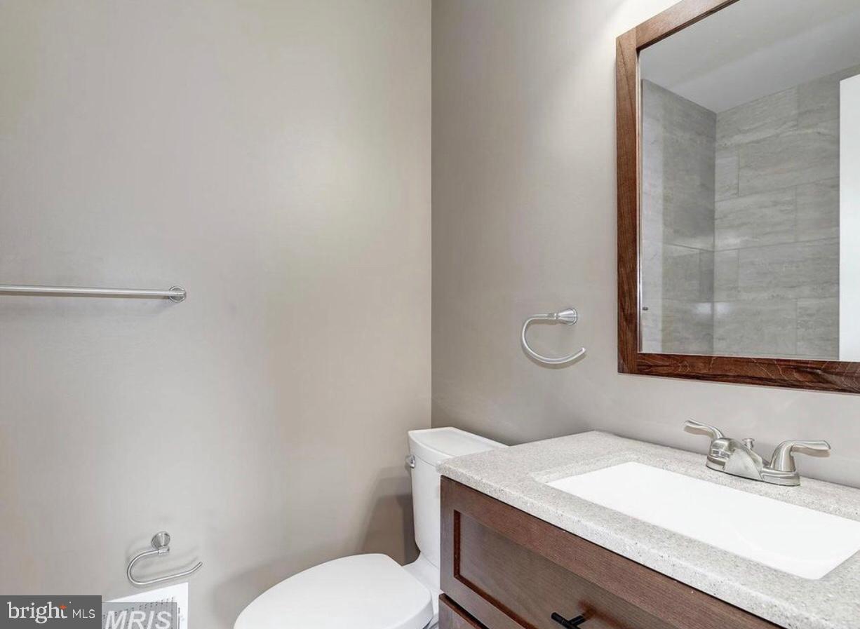 13249 # Lane Silver Spring, MD 20904 - Photo 4 of 34 a bathroom with a granite countertop sink toilet and mirror