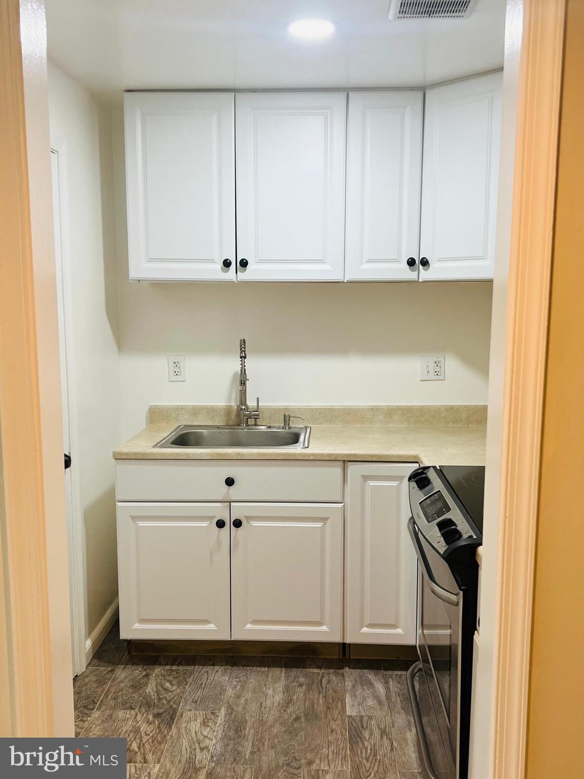 13249 # Lane Silver Spring, MD 20904 - Photo 9 of 34 a kitchen with a sink stove and cabinets