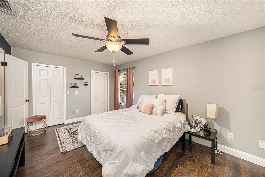 4805 Grove Point Drive Tampa, FL 33624 - Photo 14 of 35 a bedroom with a bed and wooden floor