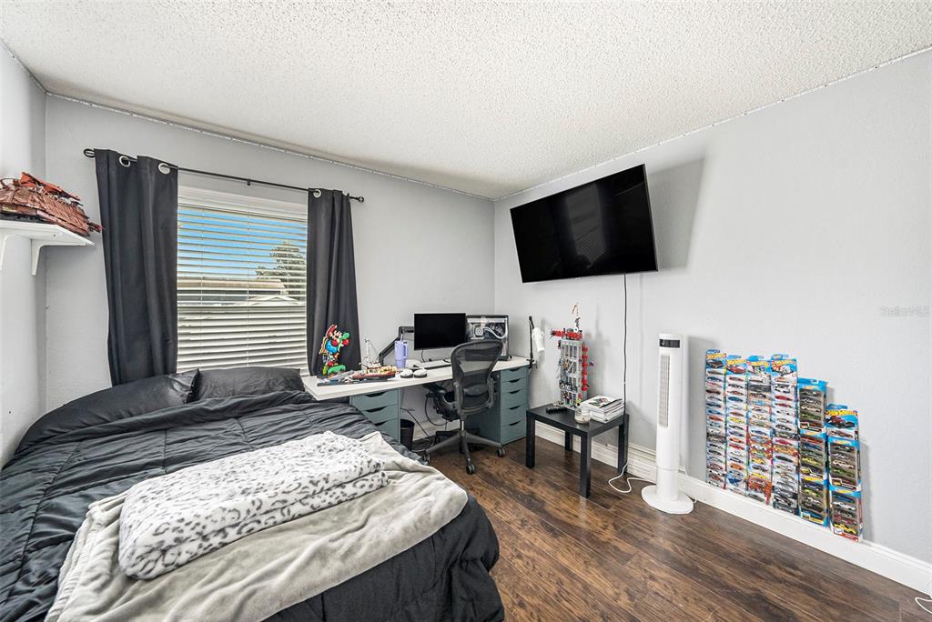 4805 Grove Point Drive Tampa, FL 33624 - Photo 20 of 35 a bedroom with a bed and a flat screen tv