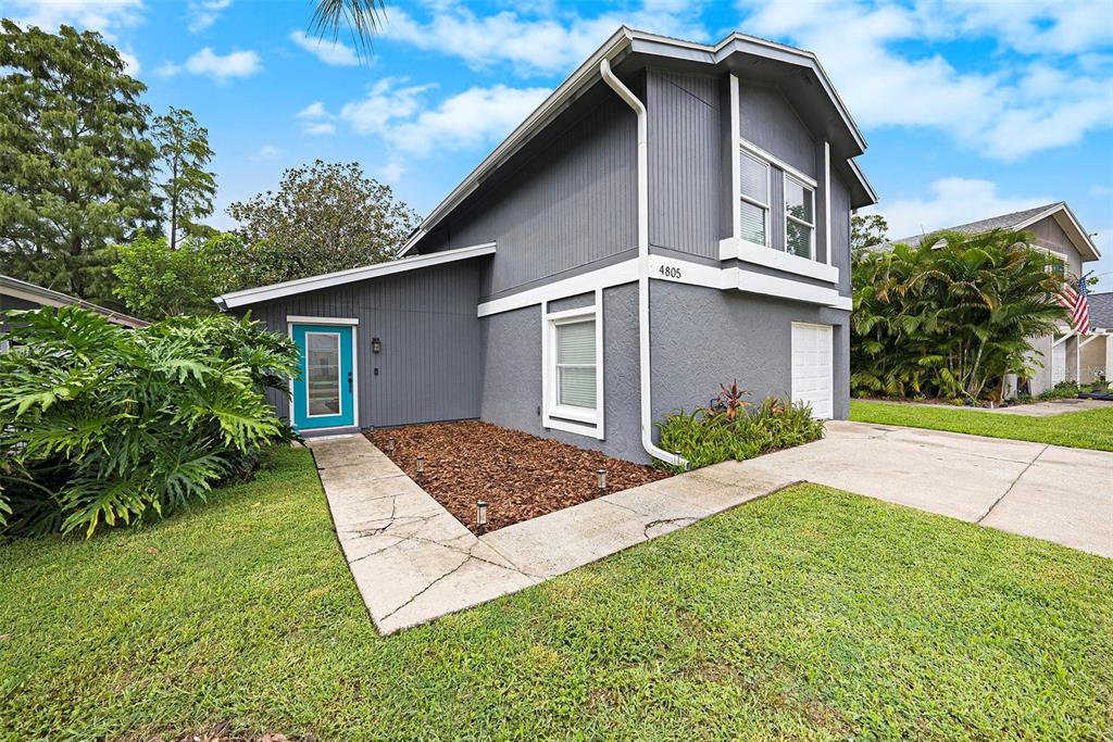 4805 Grove Point Drive Tampa, FL 33624 - Photo 2 of 35 a view of a house with yard and plants