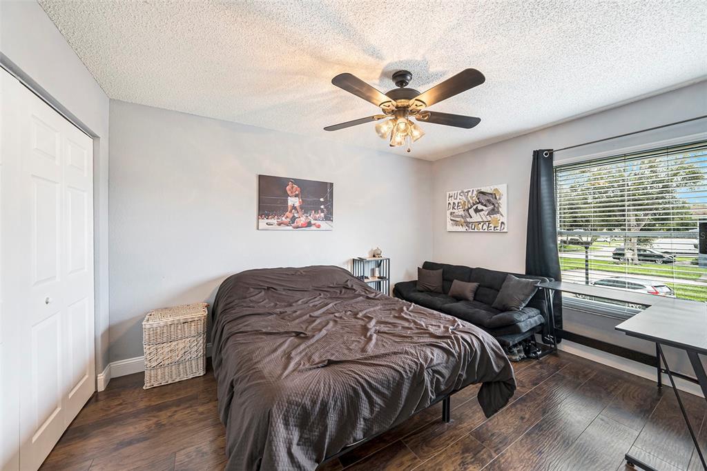 4805 Grove Point Drive Tampa, FL 33624 - Photo 22 of 35 a bedroom with a bed and a chandelier