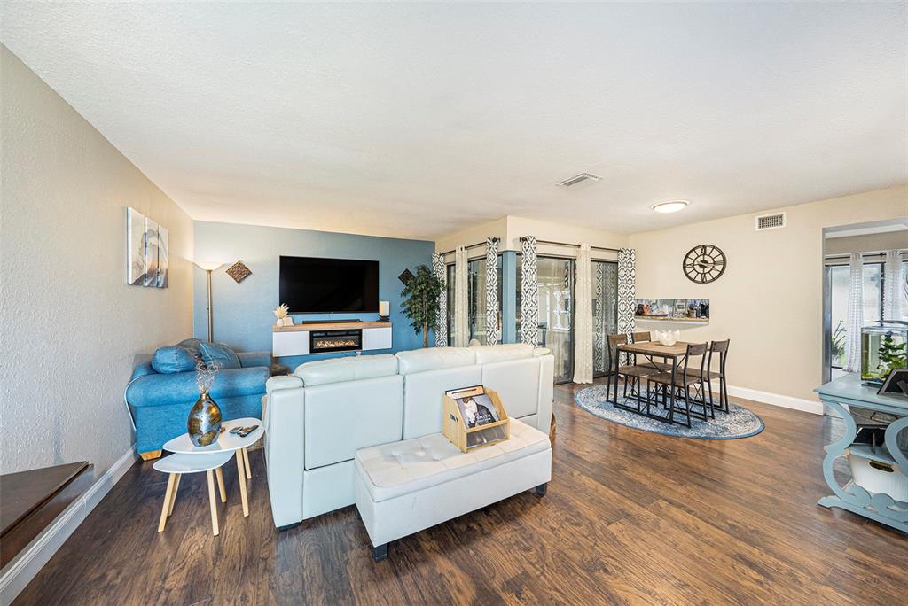 4805 Grove Point Drive Tampa, FL 33624 - Photo 3 of 35 a living room with furniture and a flat screen tv
