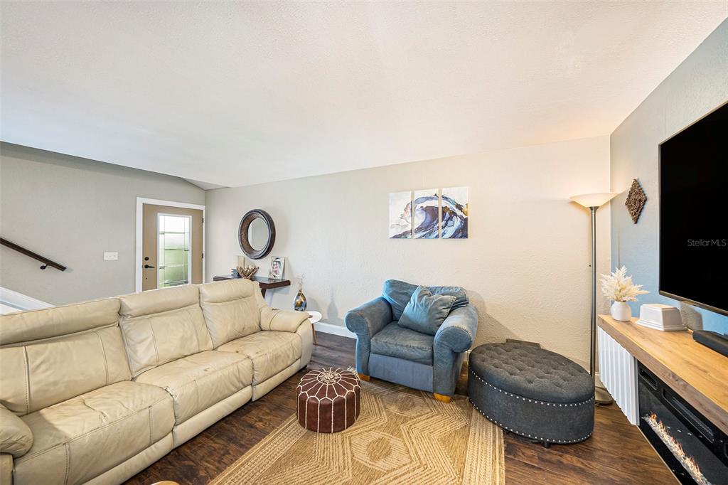 4805 Grove Point Drive Tampa, FL 33624 - Photo 5 of 35 a living room with furniture and a flat screen tv