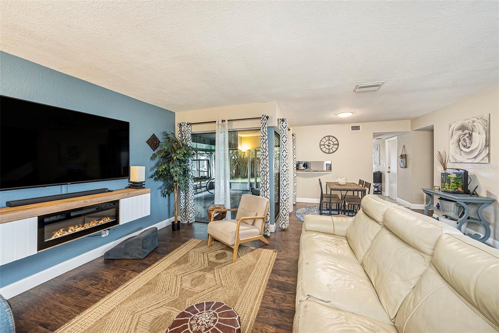 4805 Grove Point Drive Tampa, FL 33624 - Photo 6 of 35 a living room with furniture and a flat screen tv