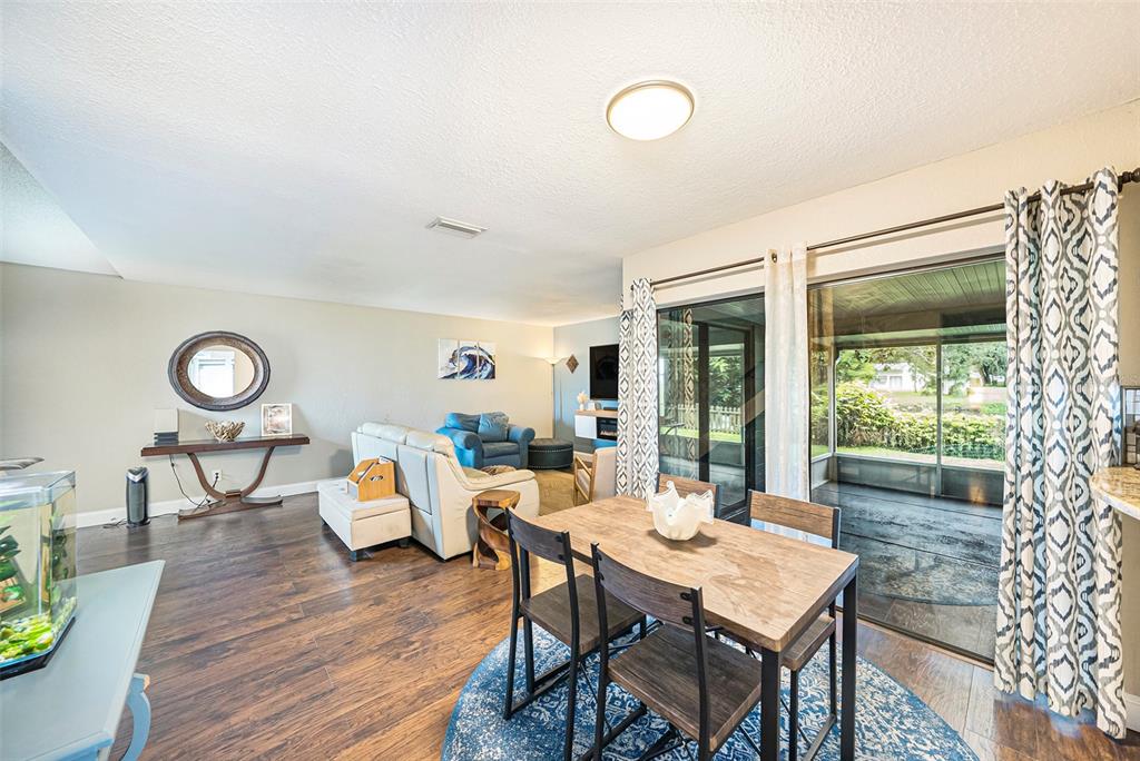 4805 Grove Point Drive Tampa, FL 33624 - Photo 8 of 35 a view of a dining room with furniture and wooden floor