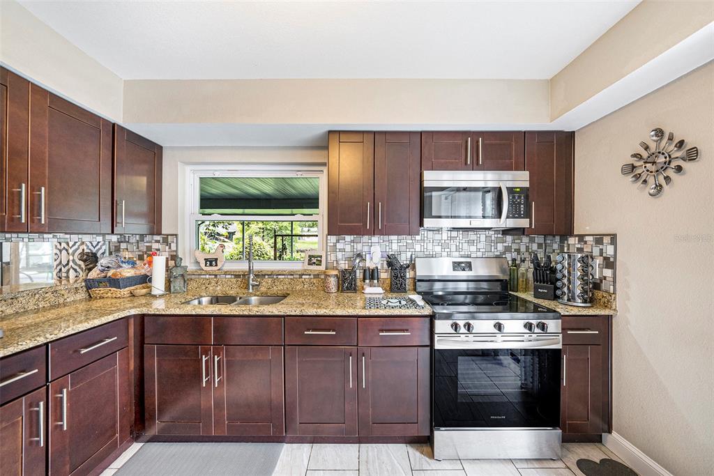 4805 Grove Point Drive Tampa, FL 33624 - Photo 9 of 35 a kitchen with a sink stove and microwave