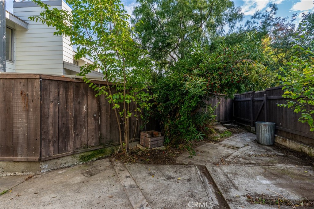 3350-74 M Street Merced, CA 95348 - Photo 40 of 55 a backyard of a house with lawn chairs and wooden fence