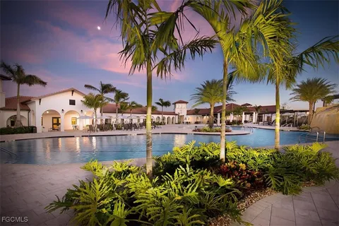 a view of swimming pool with a garden and patio