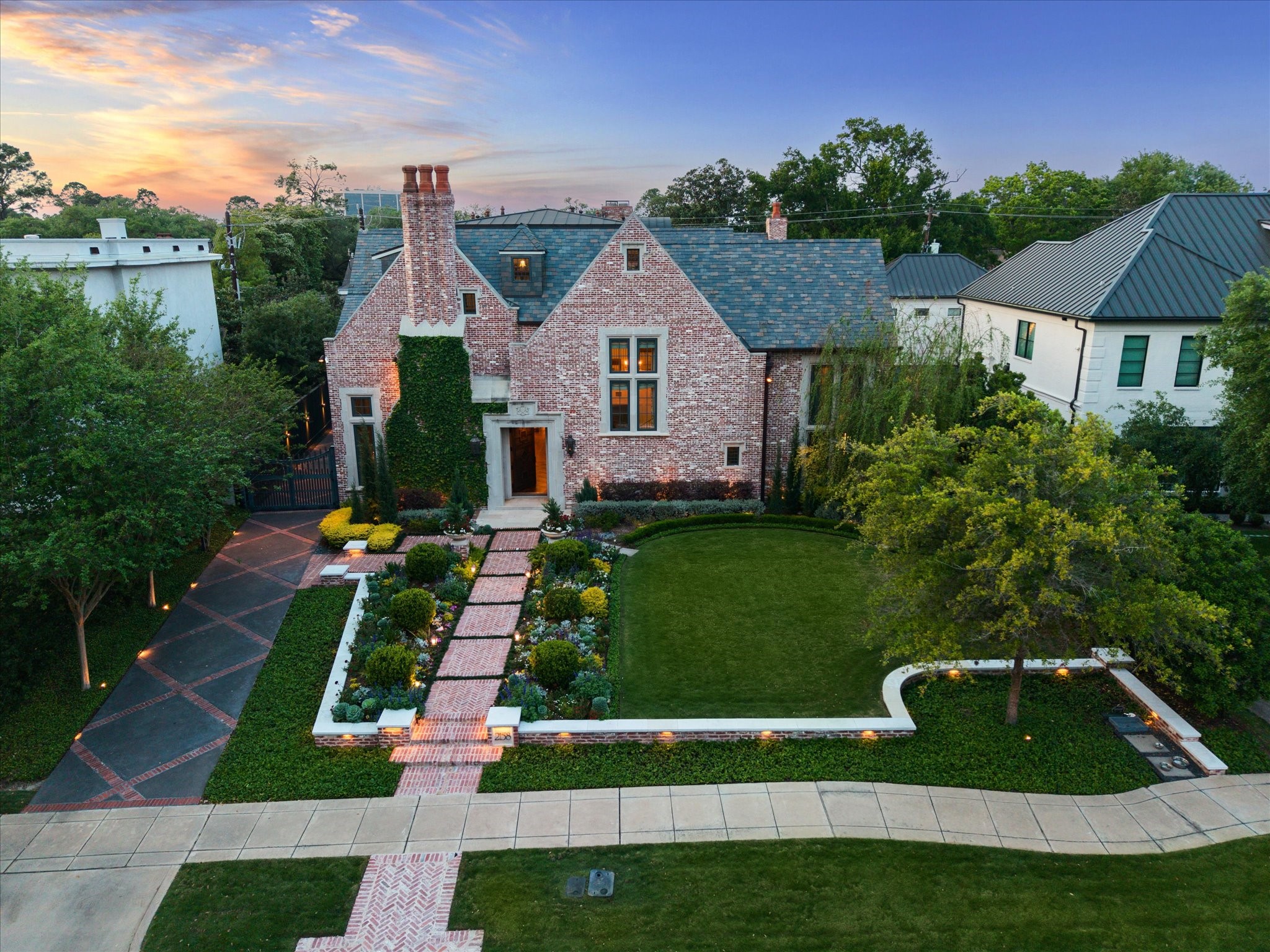 2158 Chilton Road Houston, TX 77019 - Photo 50 of 50 Located in prestigious River Oaks, this 5BD, 5.3BA home welcomes you with a spacious green lawn, manicured landscaping, and a stately two-car garage. The solid wood front door with dual lanterns sets an elegant tone for the interior.