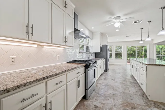 a kitchen with granite countertop a sink and cabinets