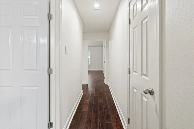 a view of a hallway with a wooden floor