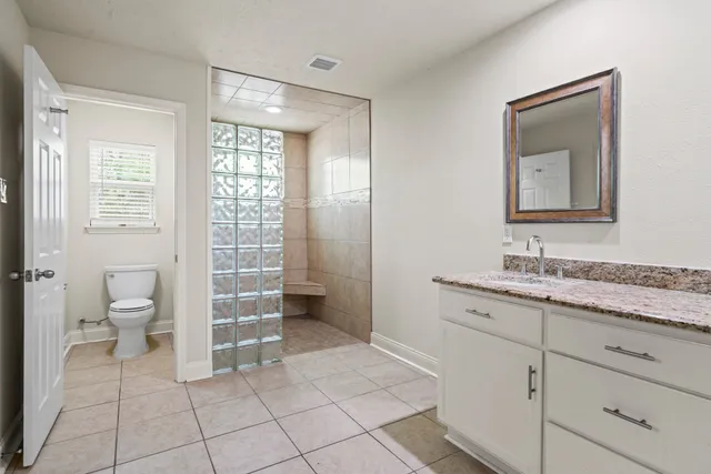 a bathroom with a toilet sink and a mirror