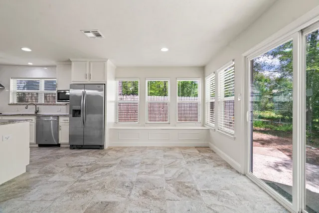 a kitchen with stainless steel appliances a refrigerator and a sink