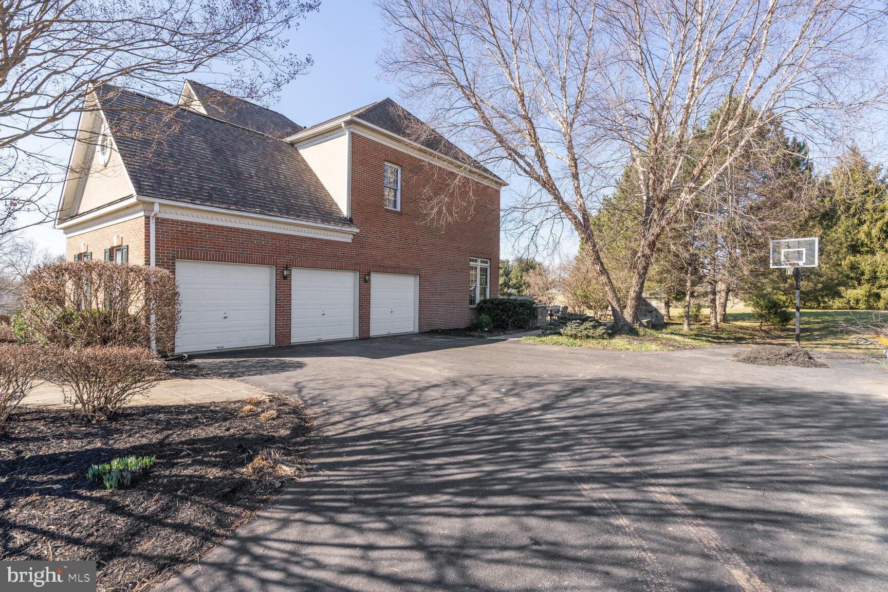 12313 Riding Fields Road Rockville, MD 20850 - Photo 28 of 42 Oversized 3 car garage & Driveway pad
