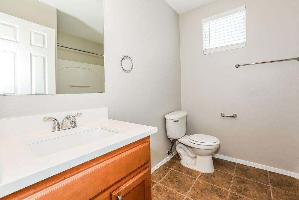 30559 North Nightingale Road San Tan Valley, AZ 85143 - Photo 15 of 16 a bathroom with a sink a toilet and a mirror