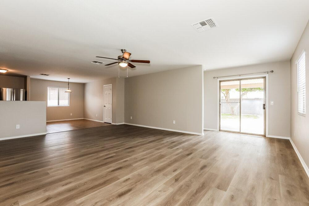 30559 North Nightingale Road San Tan Valley, AZ 85143 - Photo 3 of 16 a view of an empty room with window and wooden floor