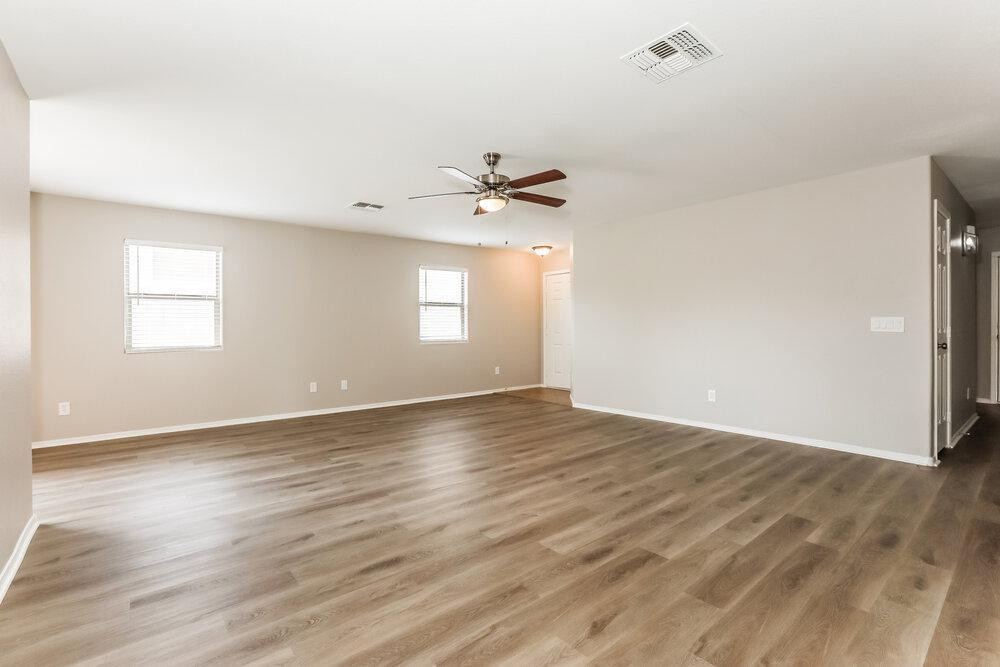 30559 North Nightingale Road San Tan Valley, AZ 85143 - Photo 5 of 16 an empty room with wooden floor and windows