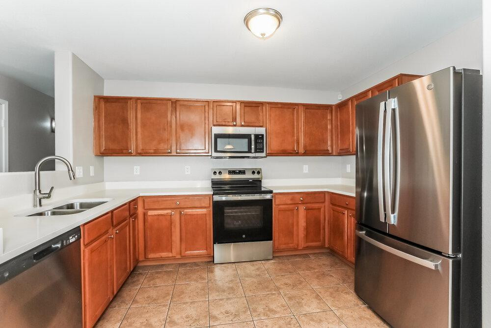 30559 North Nightingale Road San Tan Valley, AZ 85143 - Photo 7 of 16 a kitchen with stainless steel appliances granite countertop a refrigerator sink and stove