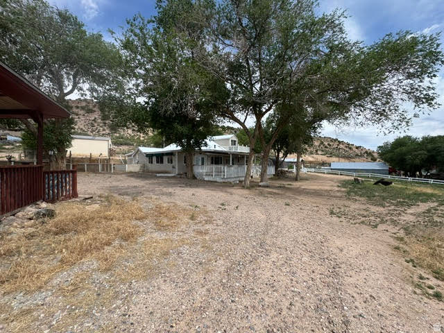 1124 Washam Road Green River, WY 82938 - Photo 3 of 35 Expansive property featuring mature trees and a gravel driveway