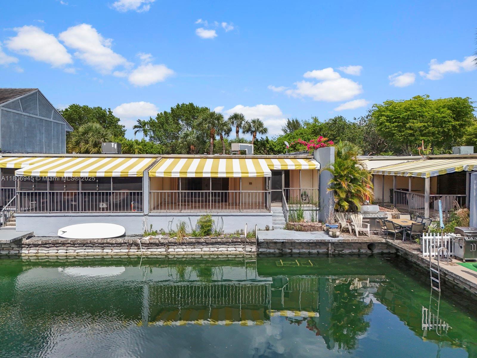 16380 Briar Patch Place Miami Lakes, FL 33014 - Photo 2 of 35 a house view with swimming pool and garden space