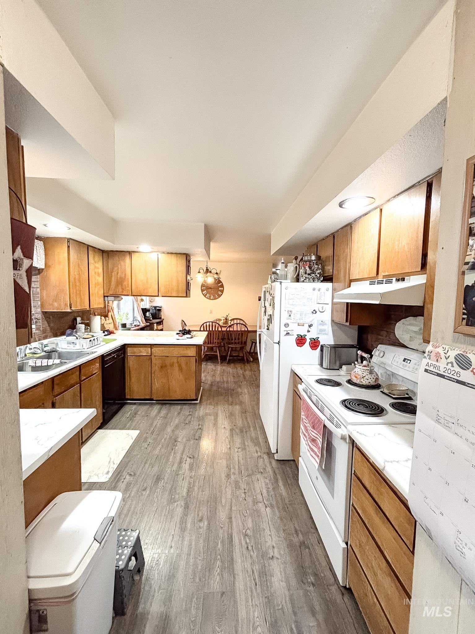 1650 Wells Bench Road Orofino, ID 83544 - Photo 11 of 44 Kitchen featuring wood-finish flooring, ample wood cabinetry, white countertops, and recessed lighting