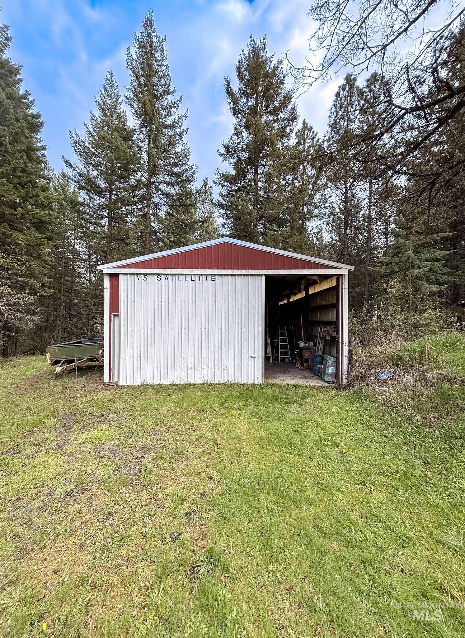 1650 Wells Bench Road Orofino, ID 83544 - Photo 28 of 44 Red and white metal utility building with an open bay