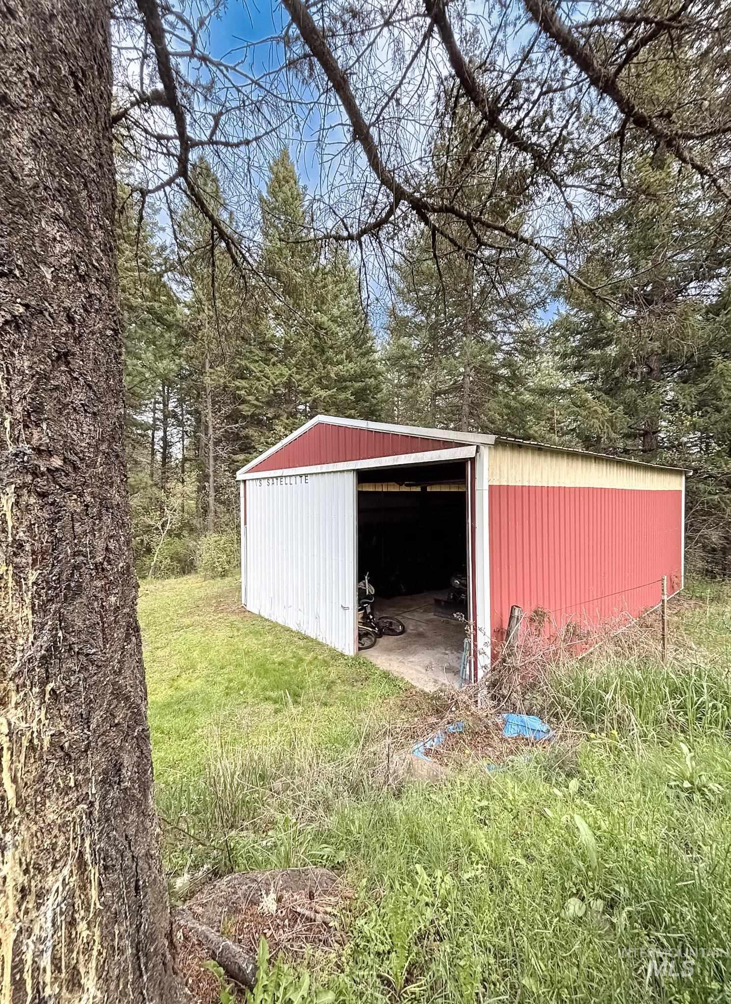 1650 Wells Bench Road Orofino, ID 83544 - Photo 29 of 44 Corrugated metal shed with a red and white exterior, featuring an open bay and a sloped roof