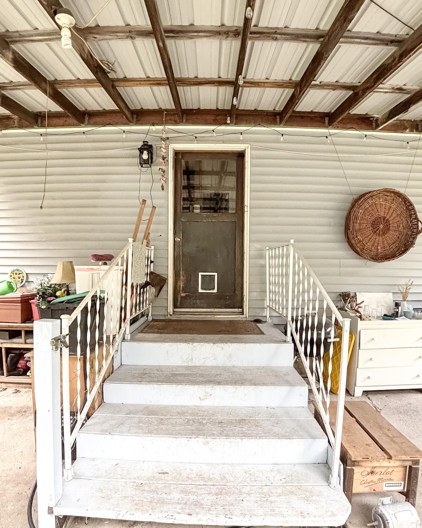 1650 Wells Bench Road Orofino, ID 83544 - Photo 3 of 44 Covered porch entry featuring white siding and a wood-finish screen door