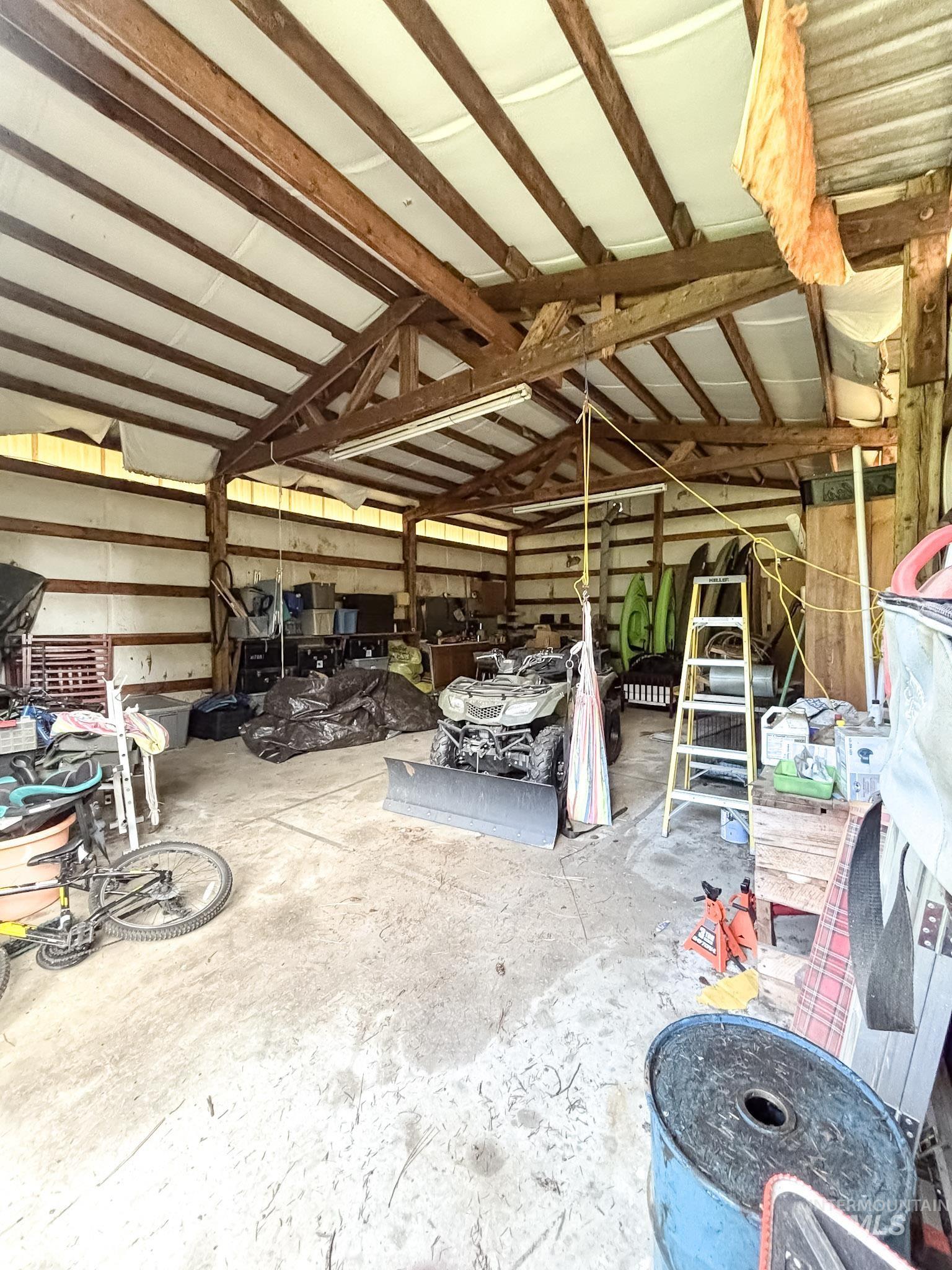 1650 Wells Bench Road Orofino, ID 83544 - Photo 31 of 44 Expansive open-sided structure featuring exposed wood beams and a concrete floor