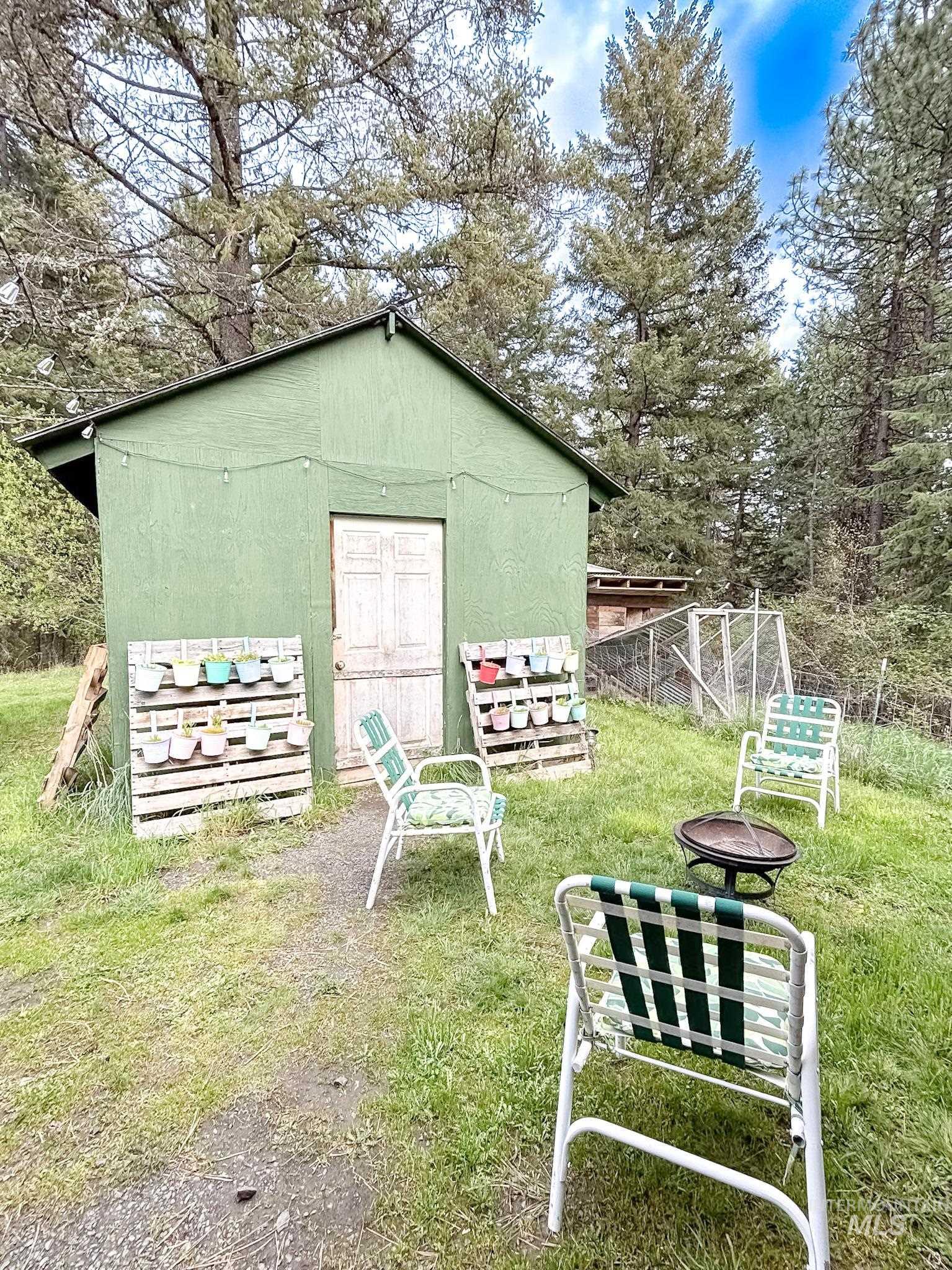 1650 Wells Bench Road Orofino, ID 83544 - Photo 32 of 44 Green shed structure with a gabled roof and a double-door entry