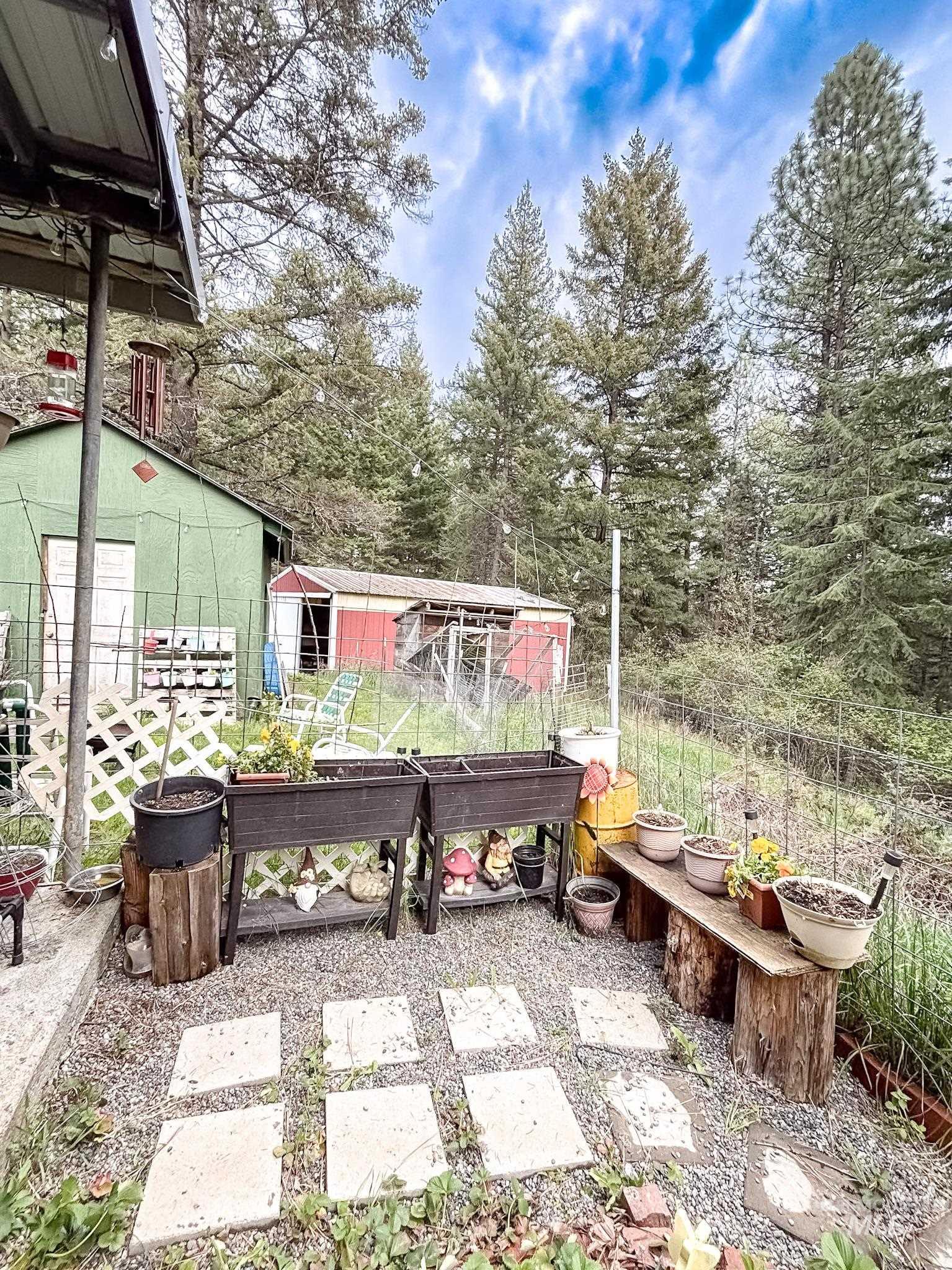 1650 Wells Bench Road Orofino, ID 83544 - Photo 5 of 44 Gravel patio area featuring stone pavers and raised garden beds