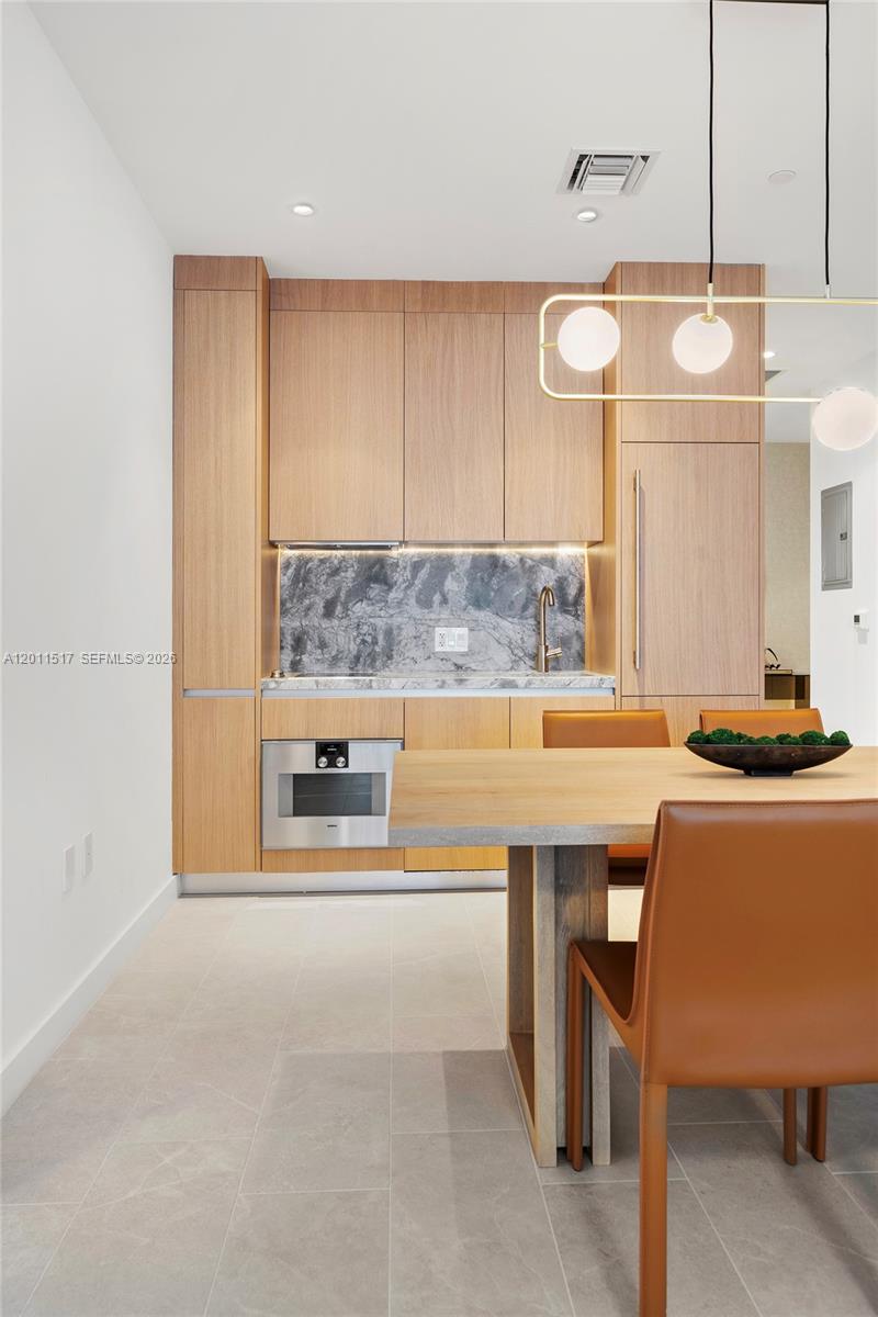 500 Alton Road, Unit 501 Miami Beach, FL 33139 - Photo 11 of 14 a large kitchen with a table and chairs