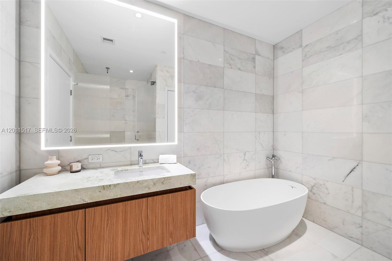 500 Alton Road, Unit 501 Miami Beach, FL 33139 - Photo 14 of 14 a bathroom with a sink and a mirror