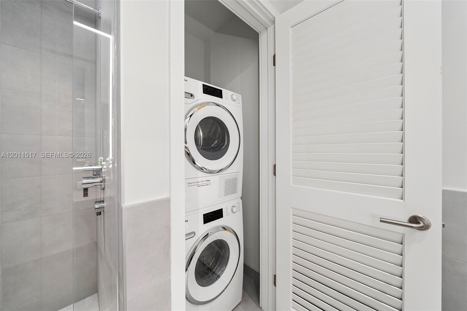 500 Alton Road, Unit 501 Miami Beach, FL 33139 - Photo 5 of 14 a view of a hallway with washer and dryer
