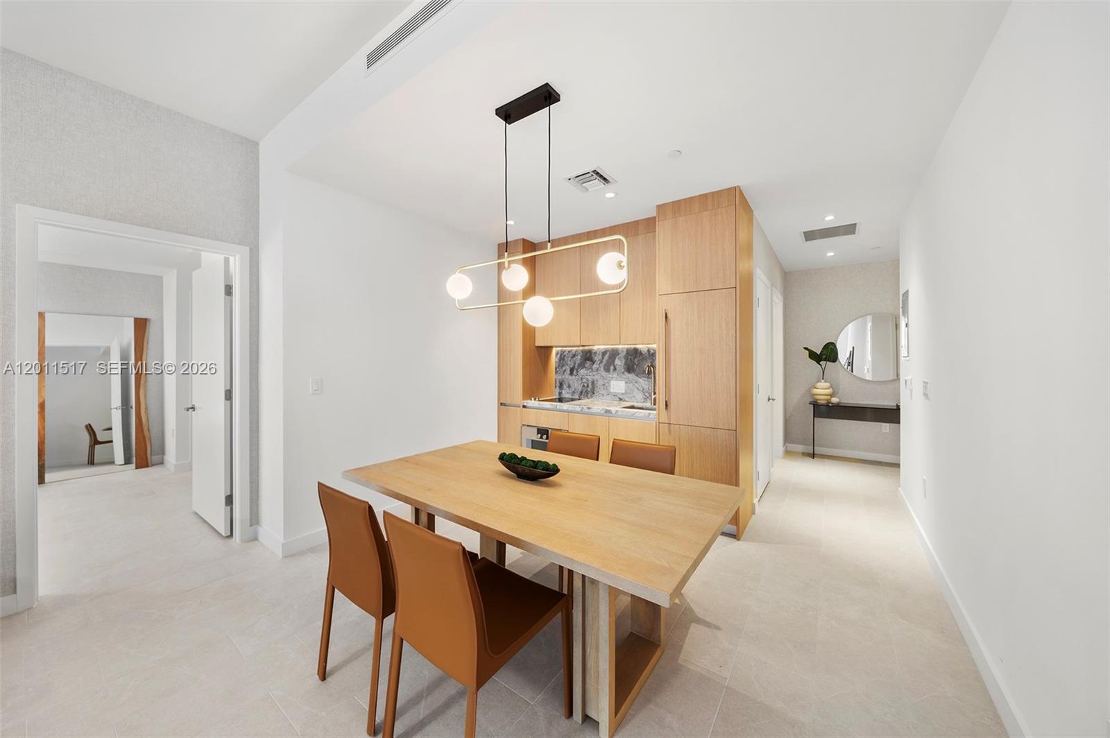 500 Alton Road, Unit 501 Miami Beach, FL 33139 - Photo 7 of 14 a view of a dining room with furniture and wooden floor