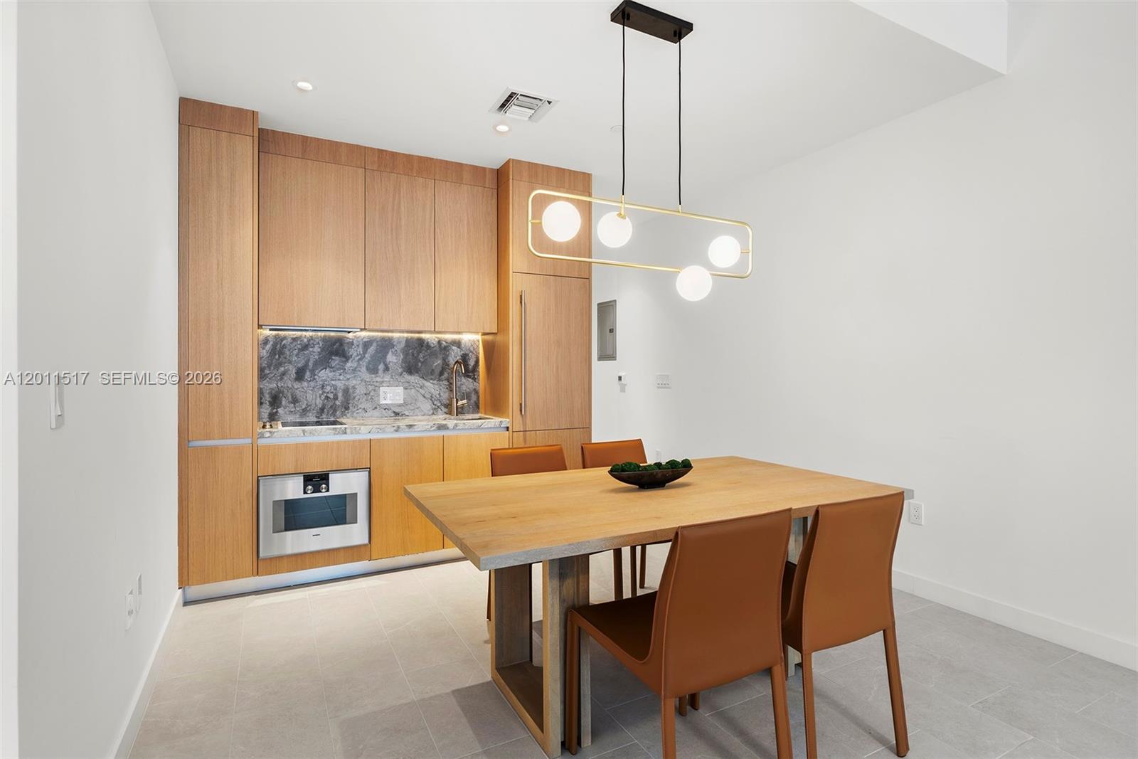 500 Alton Road, Unit 501 Miami Beach, FL 33139 - Photo 8 of 14 a kitchen with a table and chairs