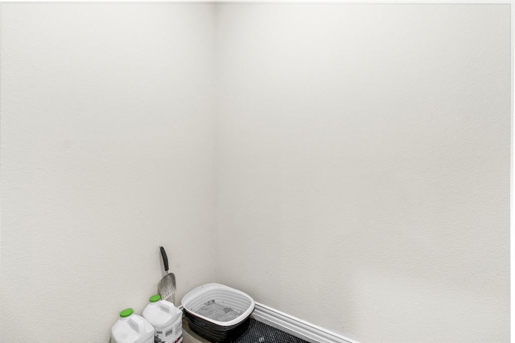 1211 Sweetleaf Street Melissa, TX 75454 - Photo 11 of 37 a white toilet sitting next to a wooden wall