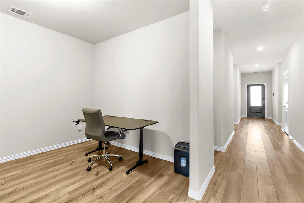 1211 Sweetleaf Street Melissa, TX 75454 - Photo 17 of 37 a view of a workspace with wooden floor and a bathroom